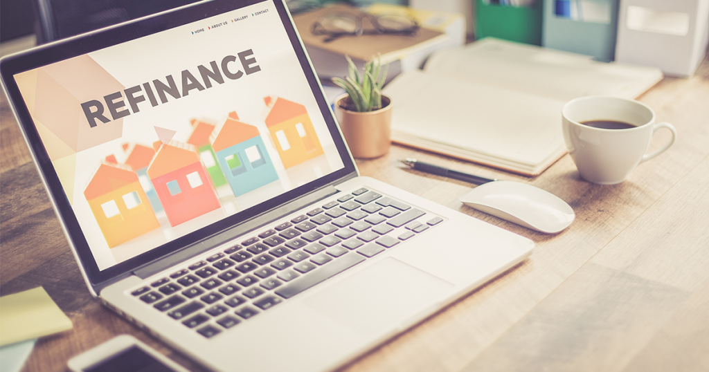 Laptop showing the word "refinance" on its screen.